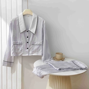 Detail of lavender silk pajama set with white mandala patterns and black piping finish