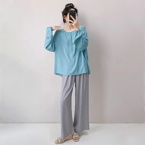 Women's zen-style pajama set with light blue long sleeve top and grey wide-leg trousers