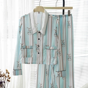 Detail of light blue striped silk pajama top with cute bunny pattern and small lapel