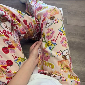 Close-up of pink pajamas pants with bear and heart cartoon prints in soft cotton fabric
