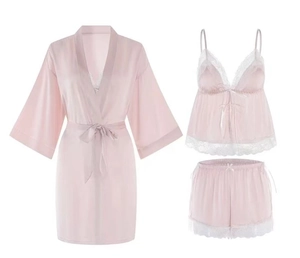 Detailed view of light pink silk sleepwear set with white lace trim and robe