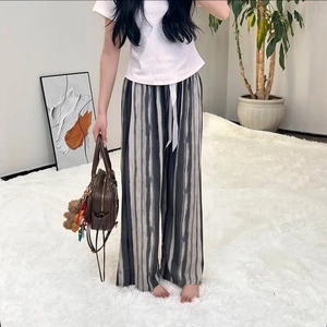Detail shot of lightweight wide-leg sleep pants with vertical stripe patterns and drawstring