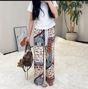 Close-up of lightweight rayon lounge pants featuring a colorful ethnic patchwork pattern