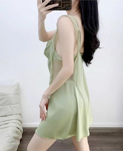 Detail of light green satin sleepwear dress with sheer mesh panels and backless design