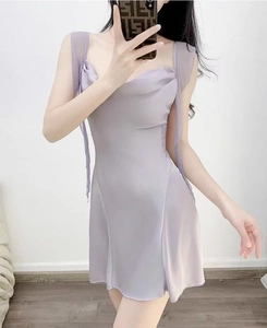 Detail of light purple satin mini sleepwear dress featuring a soft cowl neck and ribbon straps