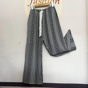 Detail of high waist wide-leg sleep pants with geometric black and white prints