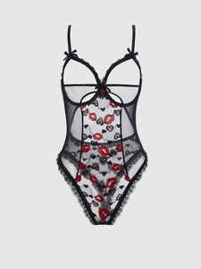 Detail view of black mesh bodysuit with heart lip prints and lace trim accents
