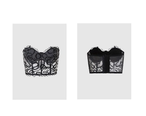 Detail view of black mesh corset top with flocked curved patterns and hook-and-eye closure