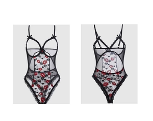 Detail of sexy black lace bodysuit with red lip prints and open crotch design