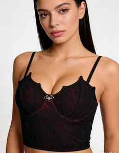 Close-up of gothic corset top with batwing neckline and silver bat metal pendant