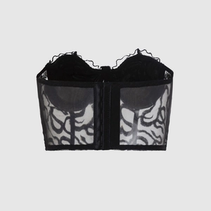 Back view of black lace corset top featuring hook and eye closure and floral mesh details