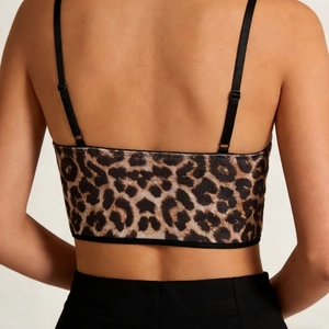 Back view of a Y2K velvet leopard print corset crop top with adjustable straps
