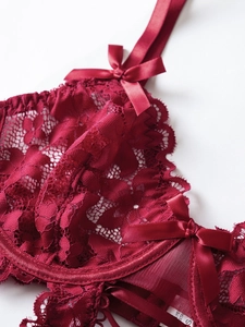 Detail of wine red floral lace bodysuit featuring satin bow and adjustable thin straps