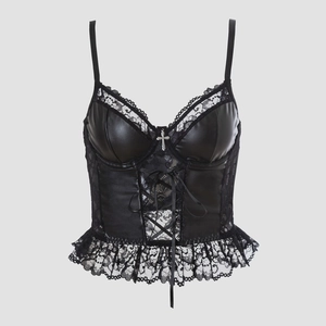 Detail of gothic black faux leather corset with lace trim and silver cross pendant
