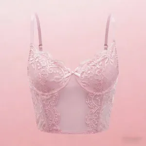 Detailed view of pale pink floral lace corset with satin bow and sheer mesh panels