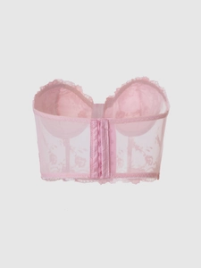Close-up of pink mesh corset back with multi-row hook-and-eye closure and lace details