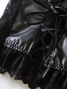 Detail of gothic black PU leather corset with floral lace splicing and ribbon lace-up design