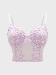 Detailed macro view of light purple lace corset with delicate floral mesh and V-shaped mesh panel