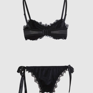 Detailed view of black lace lingerie set featuring mesh back and side-tie satin bows