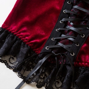 Macro detail of gothic velvet corset featuring black lace trim and silver metal eyelets