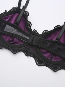 Detail of purple velvet bra with black lace trim and adjustable back straps