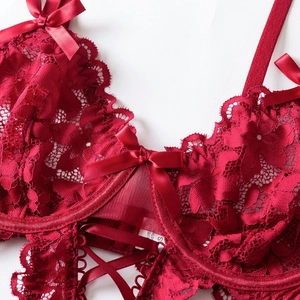 Lace bodysuit in deep red floral mesh with satin bow details and cross straps