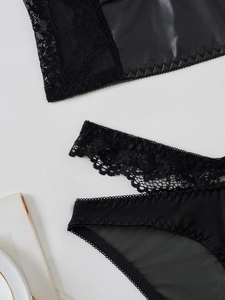 Flat lay of Gothic PU leather and lace lingerie set with intricate scallop edge detailing