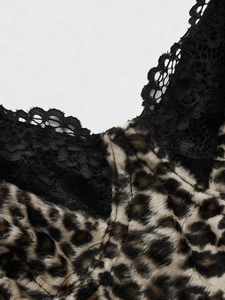 Close-up of leopard print velvet fabric with intricate black lace trim detailing