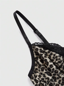 Detail of Y2K leopard print velvet camisole featuring black lace trim and adjustable strap