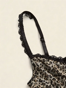 Detail of leopard print fabric with black lace trim and adjustable shoulder straps