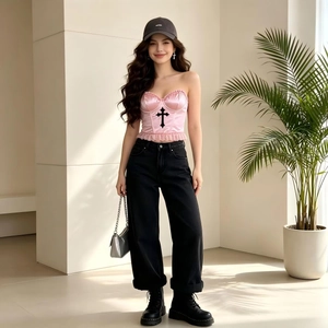 Pink satin corset top with black cross and frill details worn with black jeans