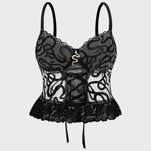 Close-up of snake embroidery on mesh corset top with metal pendant and lace hem detail