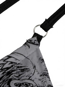 Detail of bikini top showing black elastic strap and silver O-ring on vintage print fabric