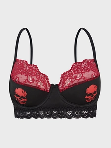 Detail of red skull print on black lace bra with scalloped trim in gothic style