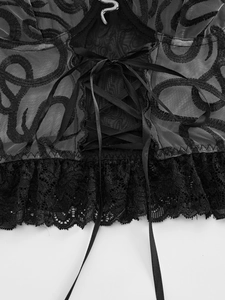 Detail of corset lacing and mesh texture with snake ornament on lace lingerie top