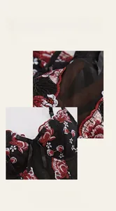 Close-up of intricate floral embroidery and satin bow on black mesh corset top