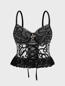 Macro view of black lace bodice featuring snake embroidery and metallic snake pendant