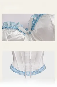 Close-up of white satin corset with blue lace trim, bow detail, and supportive boning