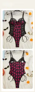 Detail display of Halloween lace bodysuit featuring red bat print and side lacing details
