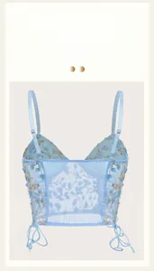 Detail of light blue mesh bra with delicate floral embroidery and breathable fabric