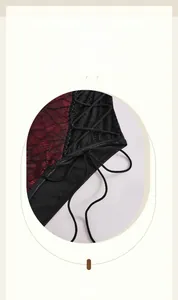 Detail of cross lace-up design featuring black lace and burgundy mesh fabric
