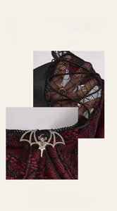 Macro detail of red and black gothic lace bodysuit with silver bat charm and lacing