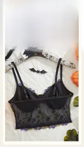 Detail of black mesh bra with purple floral embroidery and scalloped lace trim