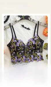 Flat lay of mesh flower embroidery underwire bra with Halloween bat and pumpkin decor