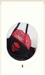 Detail of black lace bra featuring red skull print and delicate lace trim on the cups