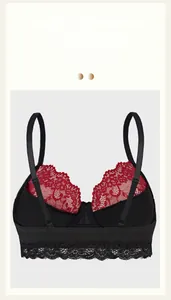 Detail of black sexy bra with red floral lace trim and breathable mesh texture
