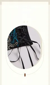 Detail of floral embroidery and black lace lace-up corset top with blue stitching