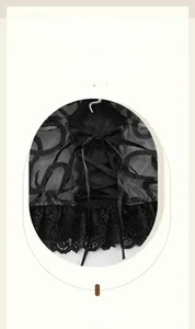 Detail of black floral lace-up corset top with sheer mesh and eyelash lace hem