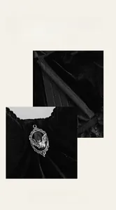 Detail of gothic black velvet corset with silver bat pendant and multi-row hook closure