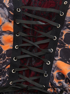 Detail of gothic corset featuring black satin laces, metal eyelets and red lace mesh